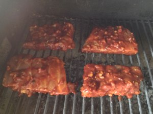 Pork ribs being smoked in the large BBQ chamber